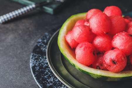 Tasty watermelon balls in ripe watermelon on dark backgroundの写真素材