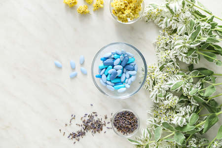 Bowl with plant based pills on light background