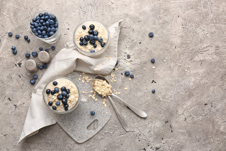 Bowls with tasty oatmeal and blueberry on tableの写真素材