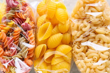 Bags with different uncooked pasta, closeupの写真素材