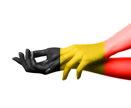 Female hands in colors of Belgian flag on white backgroundの写真素材