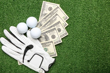 Money, golf glove and balls on color background. Concept of sports betの写真素材