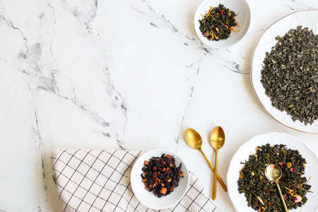 Composition with different green tea leaves in bowls on light backgroundの写真素材