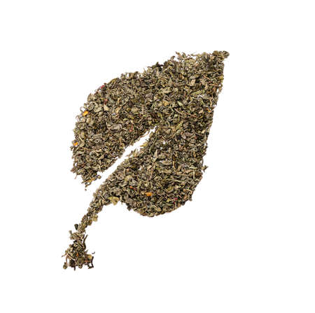 Leaf shape made of dry green tea leaves on white backgroundの写真素材