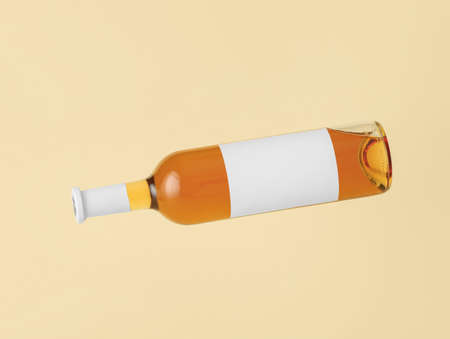 Bottle of wine with blank label on color background. Mockup for designの写真素材