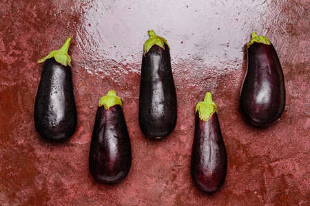 Fresh eggplants on color background