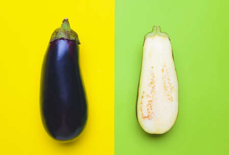Fresh and sliced eggplants on color backgroundの写真素材