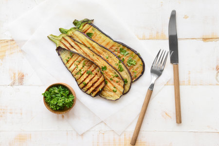 Tasty grilled eggplant and parsley on tableの写真素材