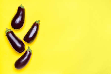 Fresh eggplants on color backgroundの写真素材