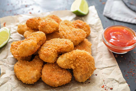 Tasty nuggets with ketchup on dark tableの写真素材