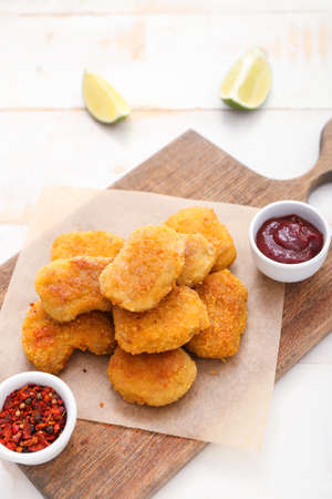 Tasty nuggets with ketchup and spices on light backgroundの写真素材