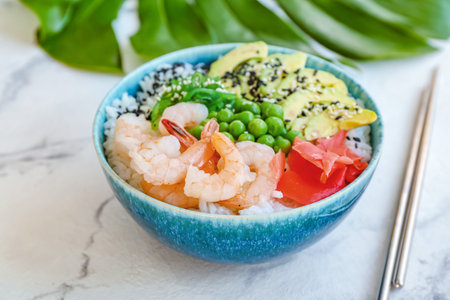 Bowl with tasty rice, shrimps and vegetables on light backgroundの写真素材