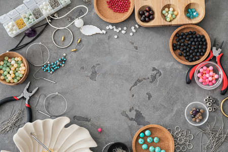 Frame made of supplies for jewelry manufacturing on grunge background
