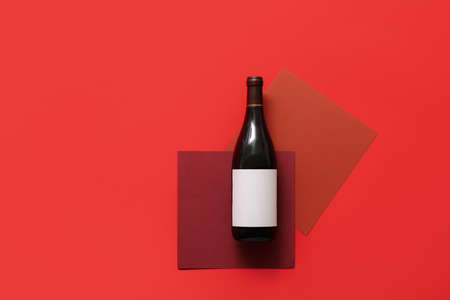Bottle of wine with blank label on color backgroundの写真素材