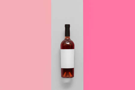 Bottle of wine with blank label on color backgroundの写真素材