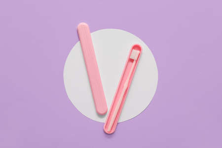 Toothbrush and case on color background
