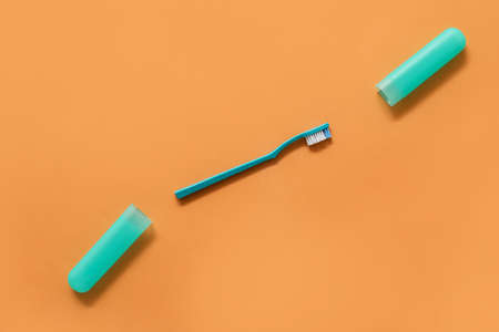 Toothbrush and case on color background