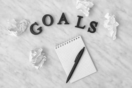 Notebook, pen and word GOALS on light backgroundの写真素材