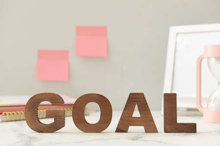 Word GOAL made of wooden letters on tableの写真素材