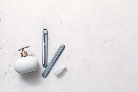 Toothbrush, case and cosmetic bottles on light backgroundの写真素材