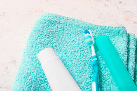 Set for oral hygiene with towel on light background