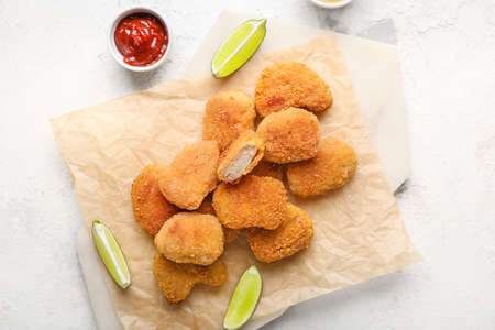 Board with tasty nuggets on grunge backgroundの写真素材