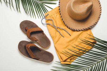 Male swimsuit, hat and flip-flops on white backgroundの写真素材