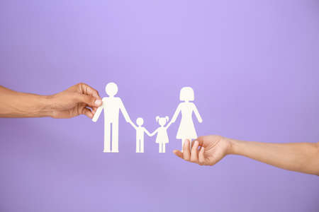 Hands of family with human figures on color backgroundの写真素材
