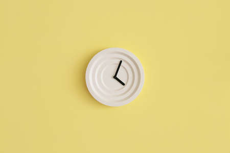 Modern clock hanging on color wall