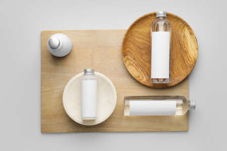 Different bottles of cosmetic products on light backgroundの写真素材