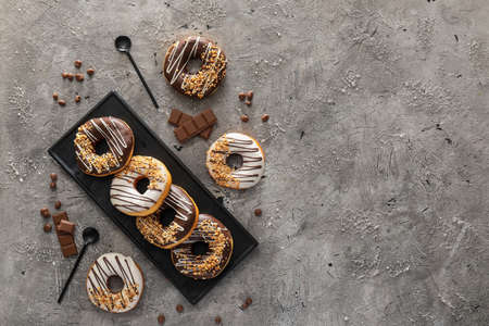 Plate with tasty donuts on tableの写真素材