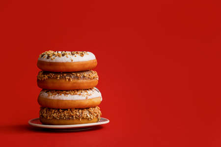 Sweet tasty donuts on color backgroundの写真素材