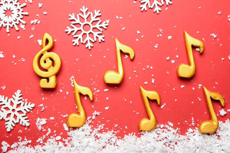 Music notes with Christmas decor on color backgroundの写真素材