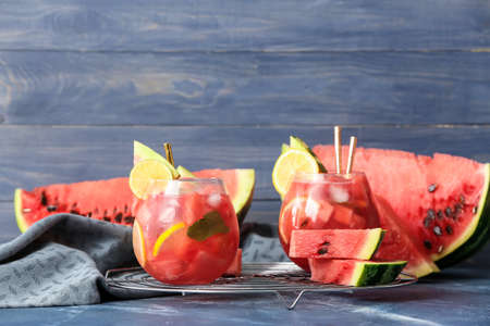 Glasses of tasty cold watermelon lemonade on color backgroundの写真素材