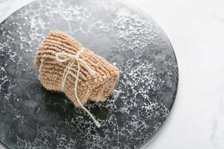 Composition with loofah on dark boardの写真素材
