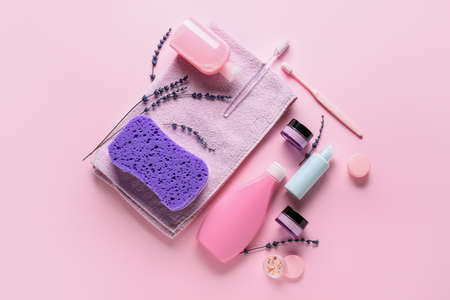 Composition with bath accessories and cosmetics on color background