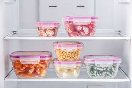 Containers with frozen vegetables in refrigeratorの写真素材