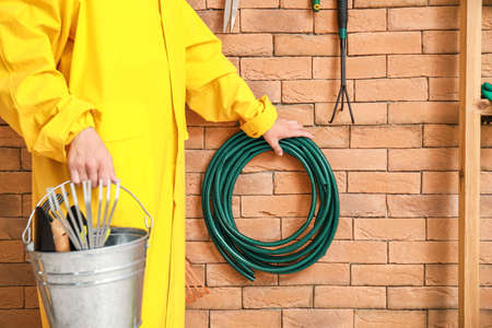 Man with gardening tools in barnの写真素材