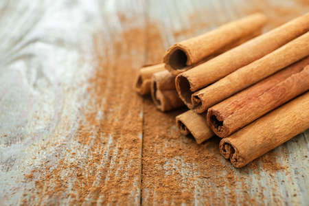 Cinnamon sticks on wooden background, closeupの写真素材