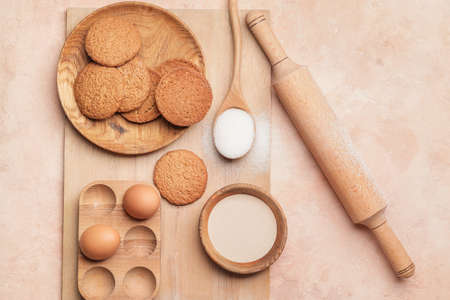 Ingredients for cookies and rolling pin on color backgroundの写真素材