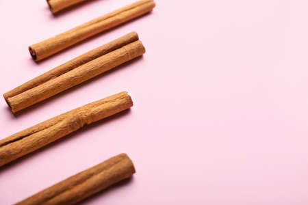 Cinnamon sticks on color background