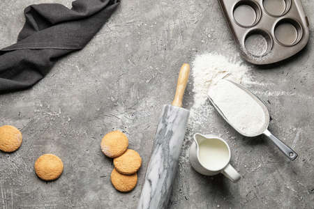 Ingredients for dough and rolling pin on gray backgroundの写真素材