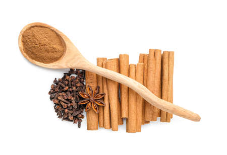 Composition with cinnamon and cloves on white background