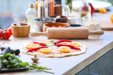 Raw pizza on kitchen tableの写真素材