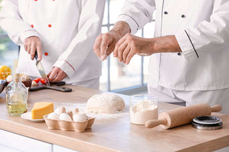 Chefs cooking tasty dish in kitchenの写真素材