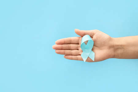 Female hand with awareness ribbon on color background. Diabetes conceptの写真素材