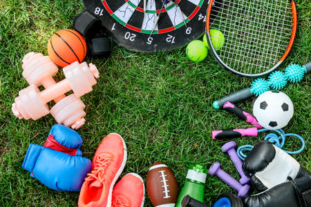 Frame made of sport equipment on green grassの写真素材
