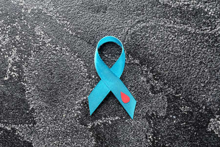 Awareness ribbon on dark background. Diabetes concept