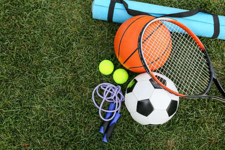 Set of sport equipment on green grassの写真素材