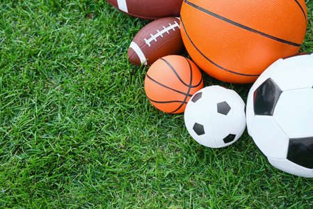 Set of sport equipment on green grassの写真素材